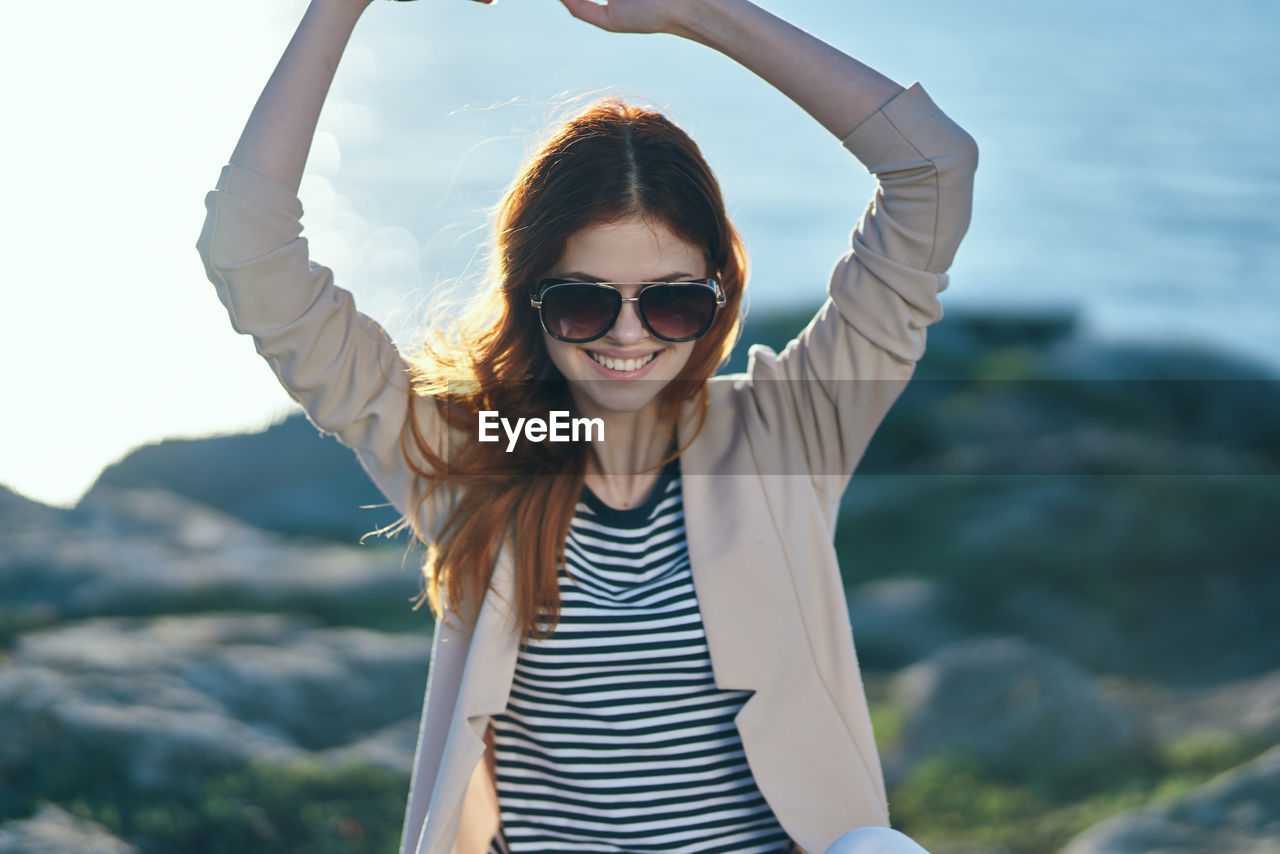 Portrait of smiling young woman standing outdoors