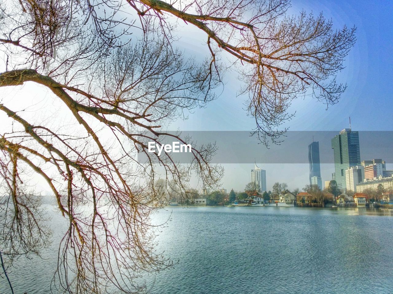 RIVER WITH BUILDINGS IN BACKGROUND AGAINST SKY