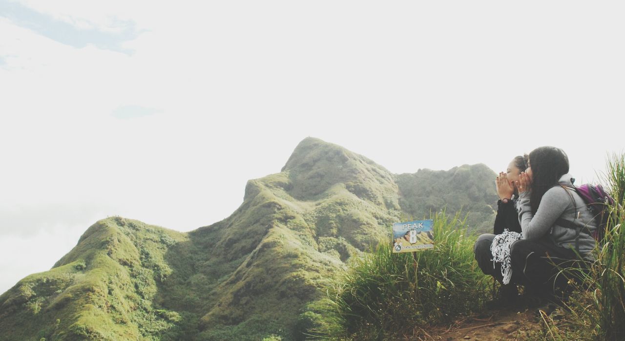 MAN STANDING ON MOUNTAIN