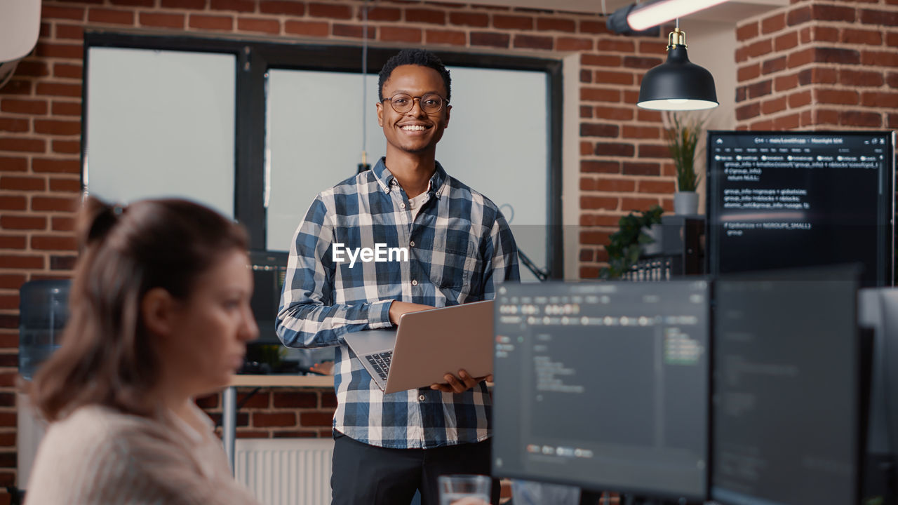 Portrait of smiling businessman at office