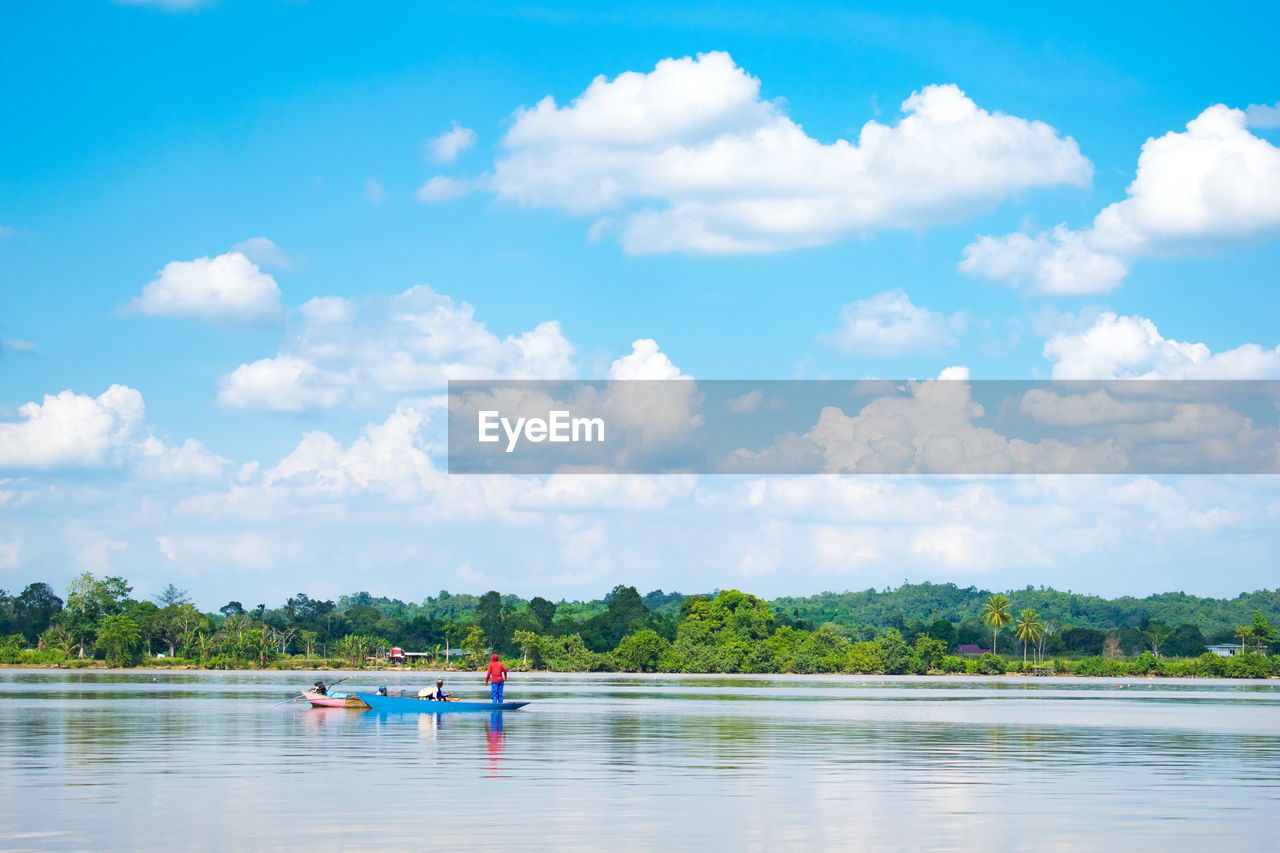 BOAT IN LAKE AGAINST SKY