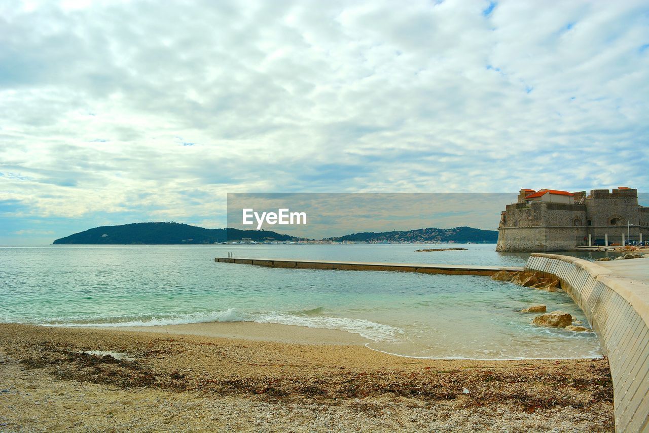Scenic view of sea against cloudy sky