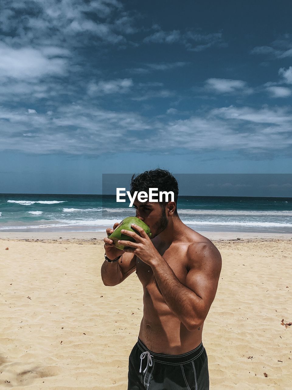 Enjoying coconut at the beach