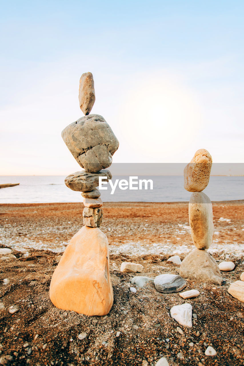 ROCKS ON SHORE AGAINST SKY