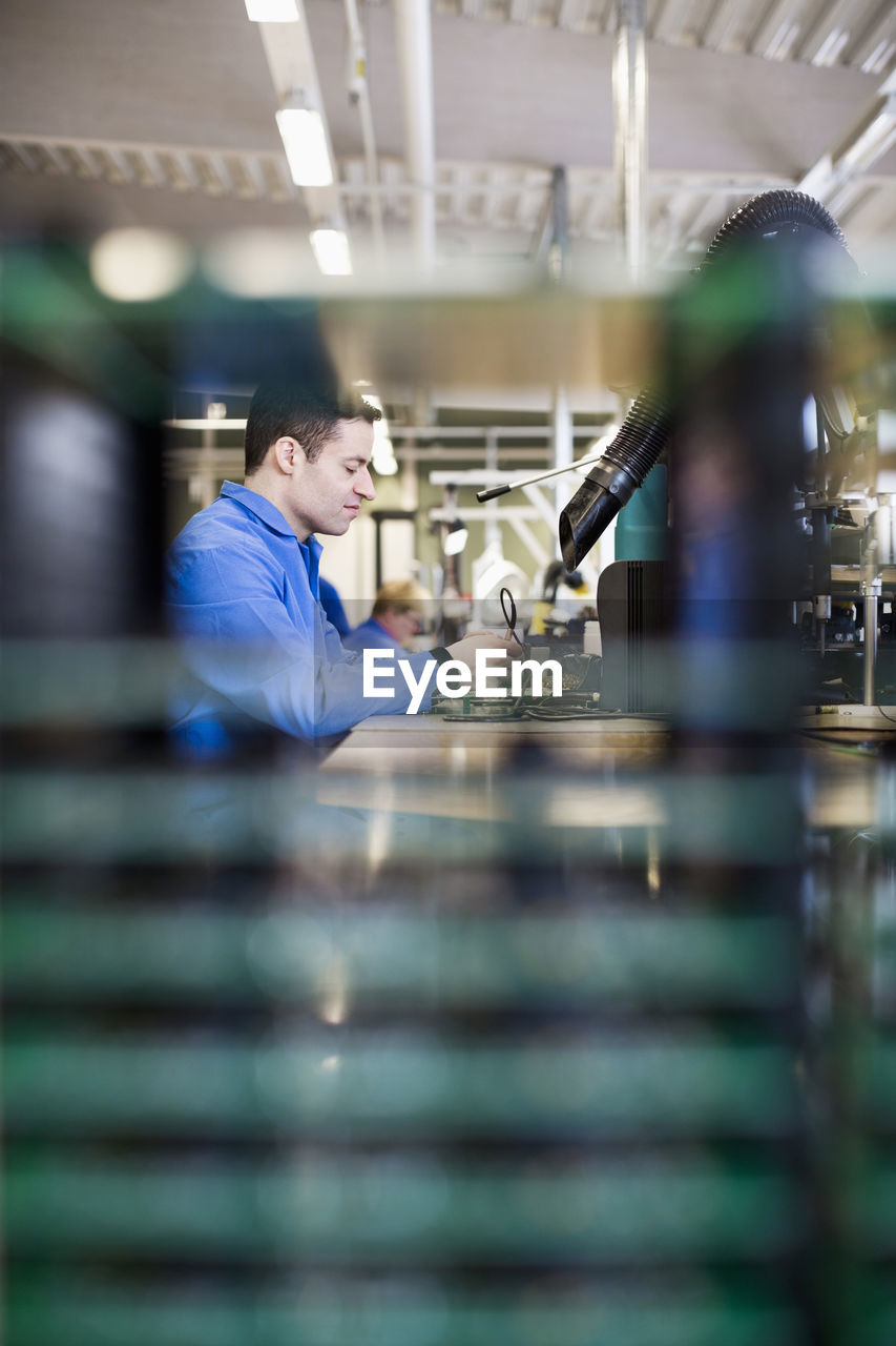 Selective focus of male electrician working in industry