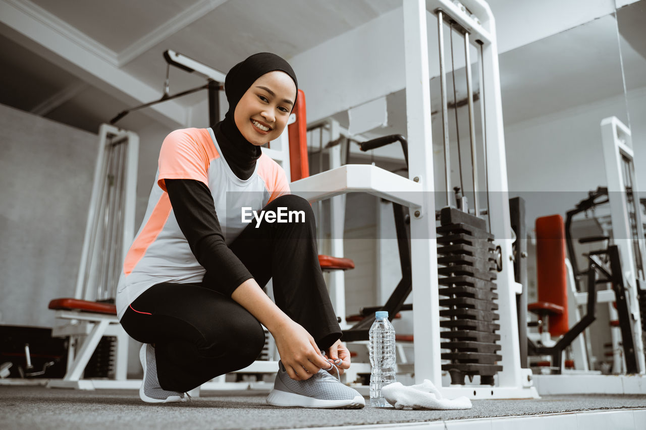 young woman exercising at gym