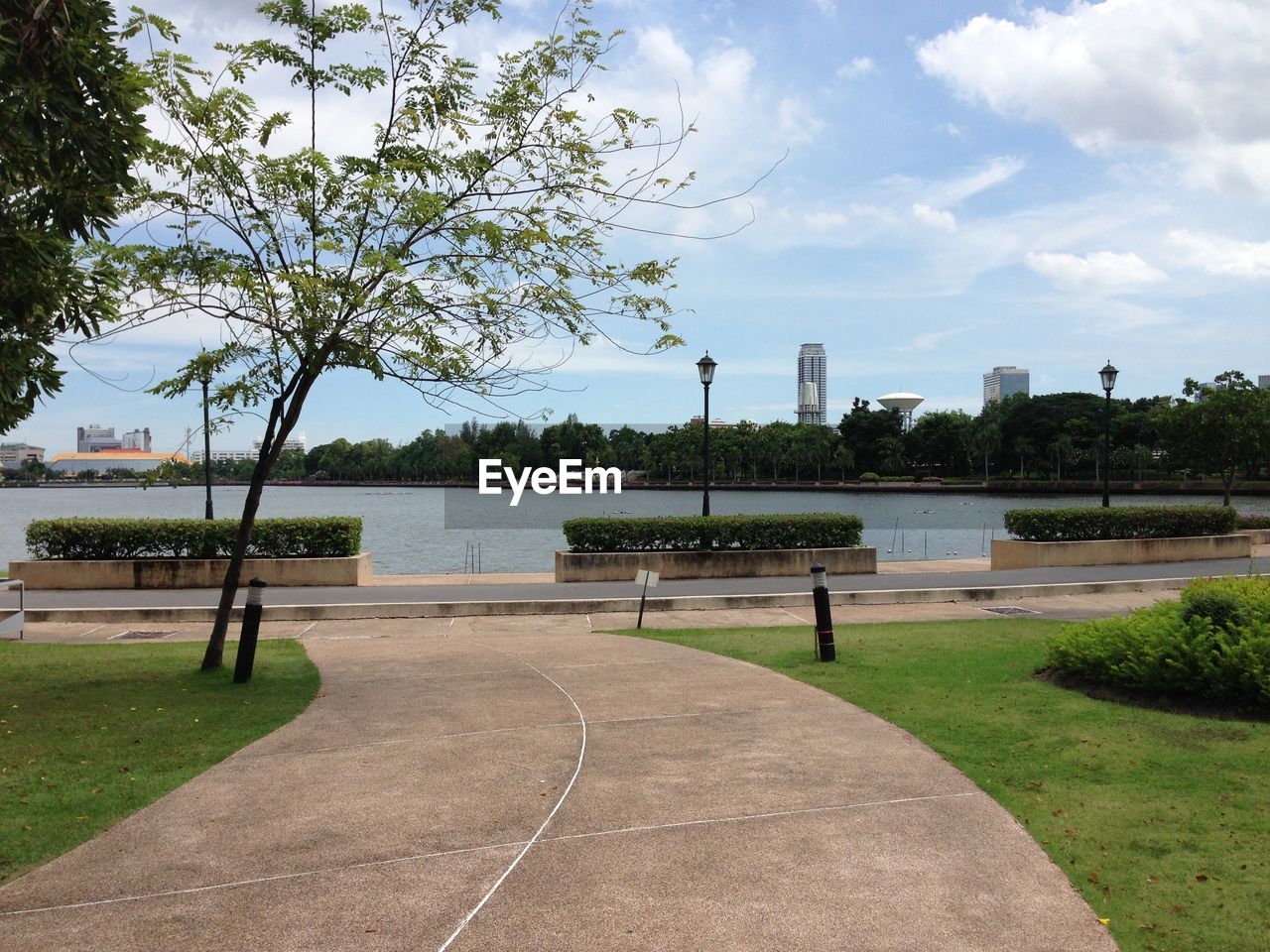 Scenic view of park by river against sky