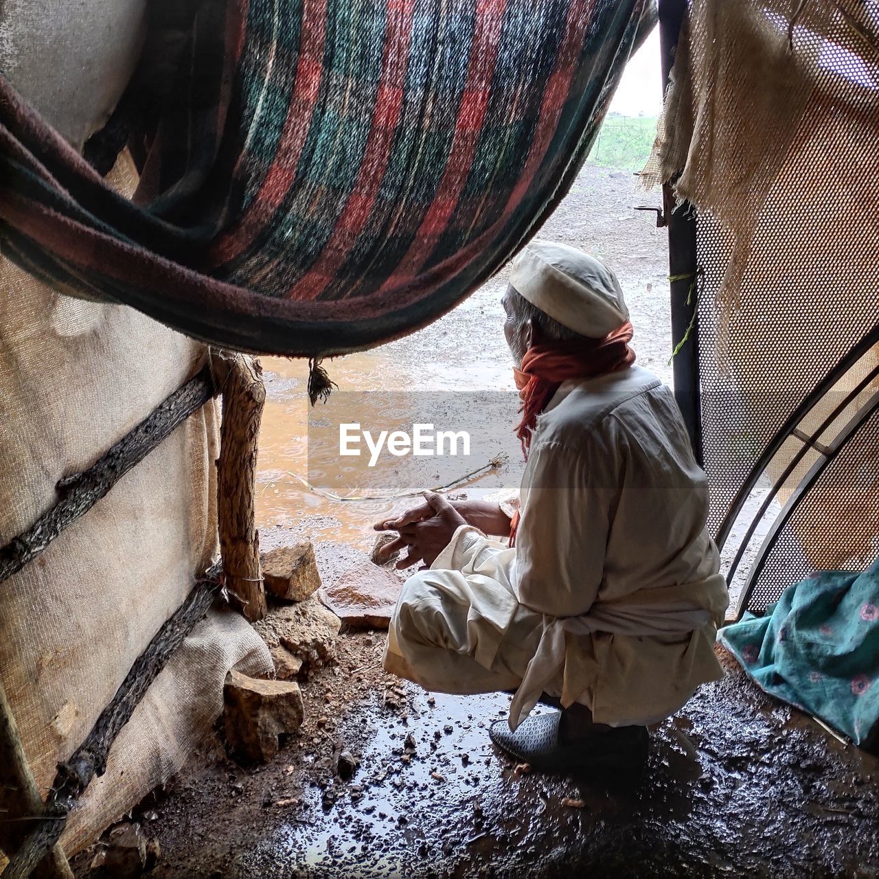 Farmer looking at the rain