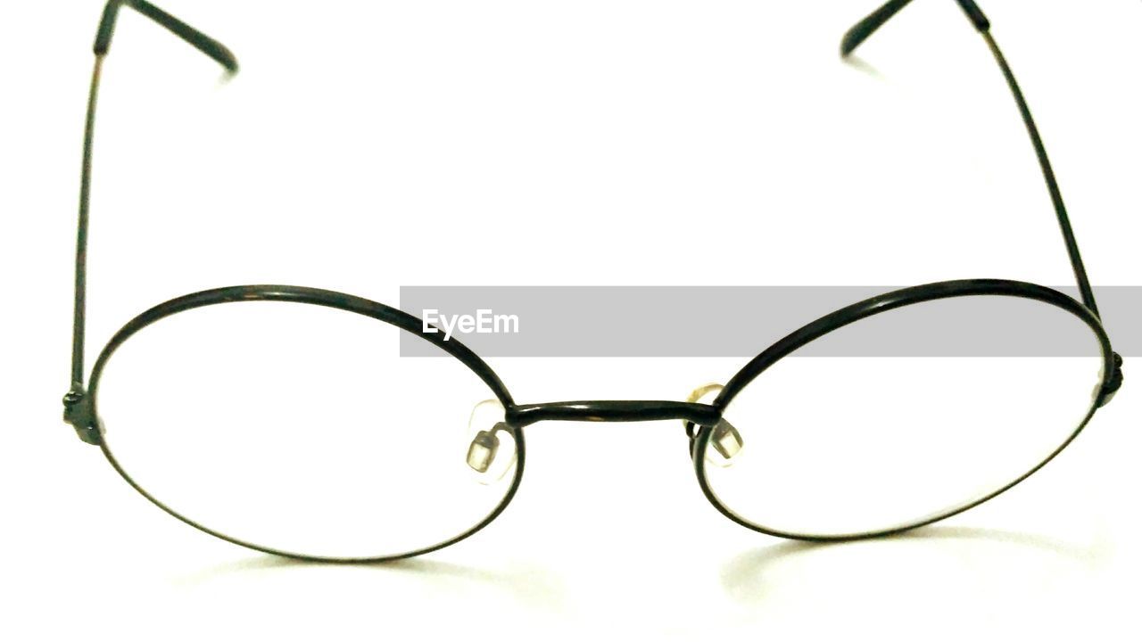 CLOSE-UP OF EYEGLASSES ON GLASS