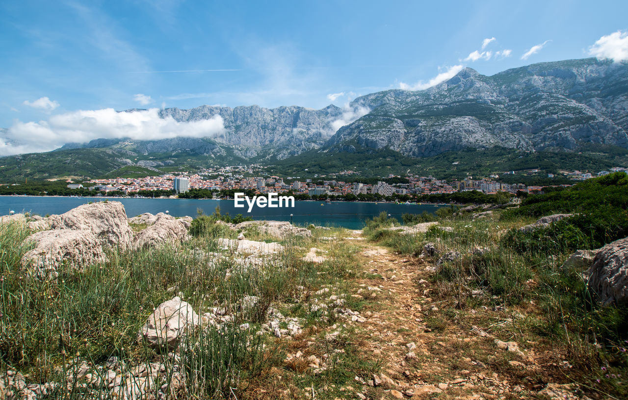 Scenic view of lake and mountains against sky