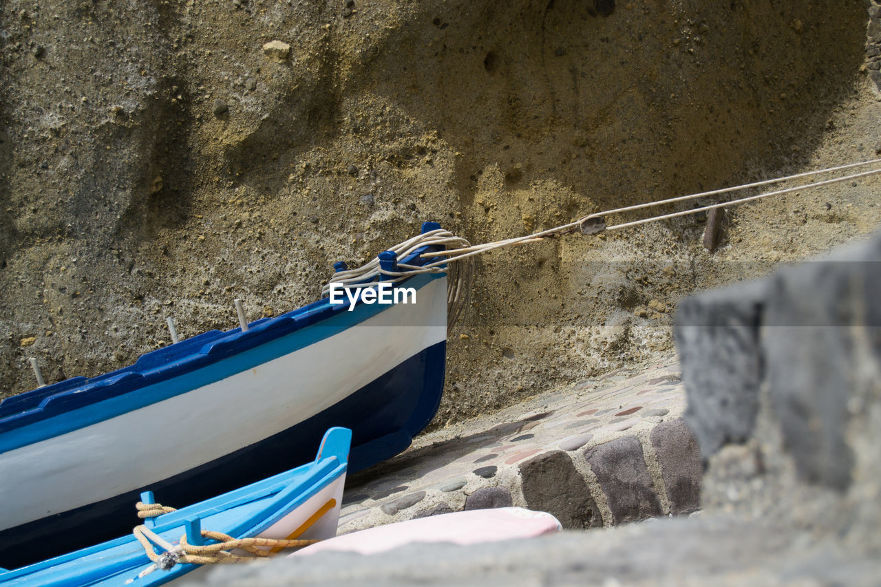 Boats moored against wall