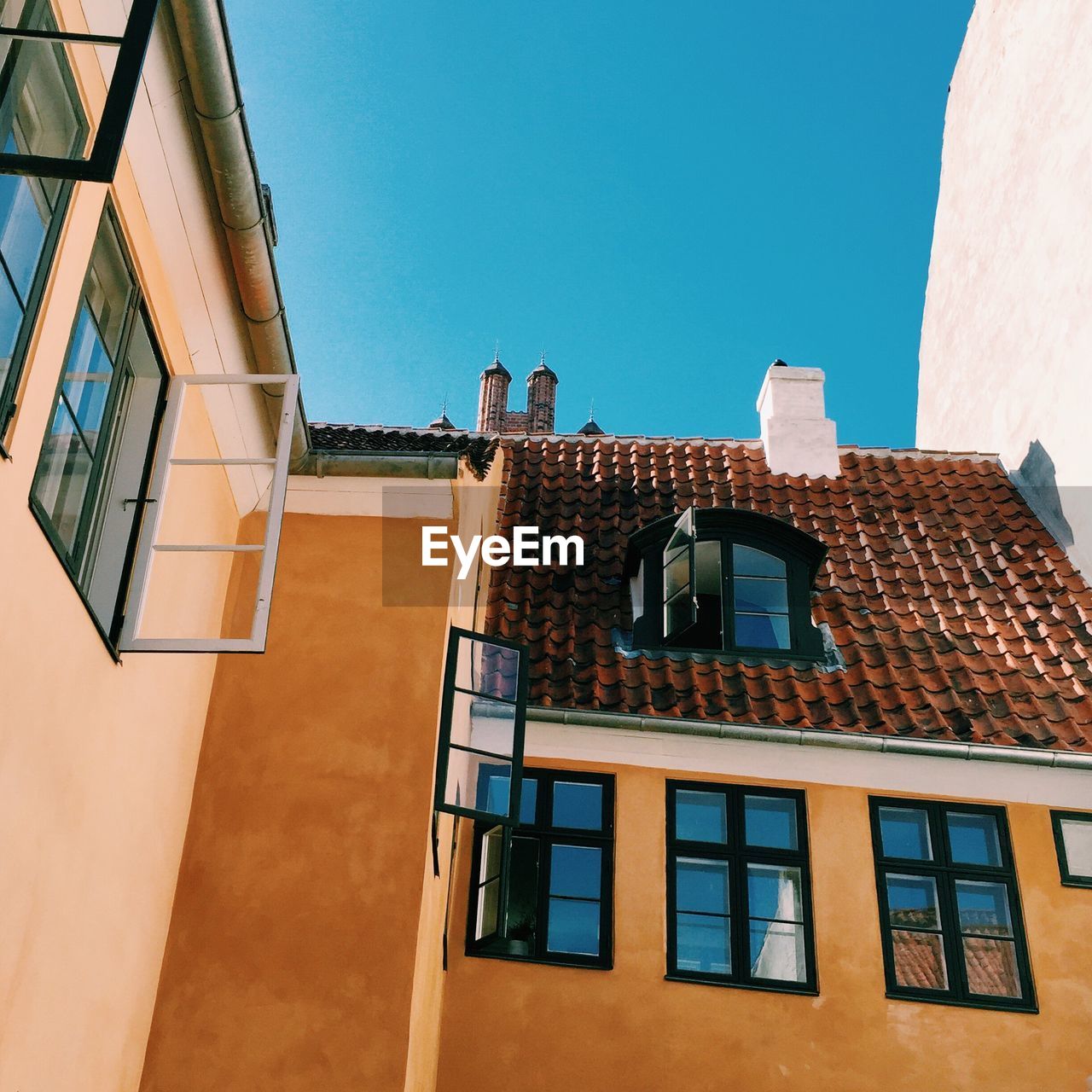 Low angle view of building against clear blue sky