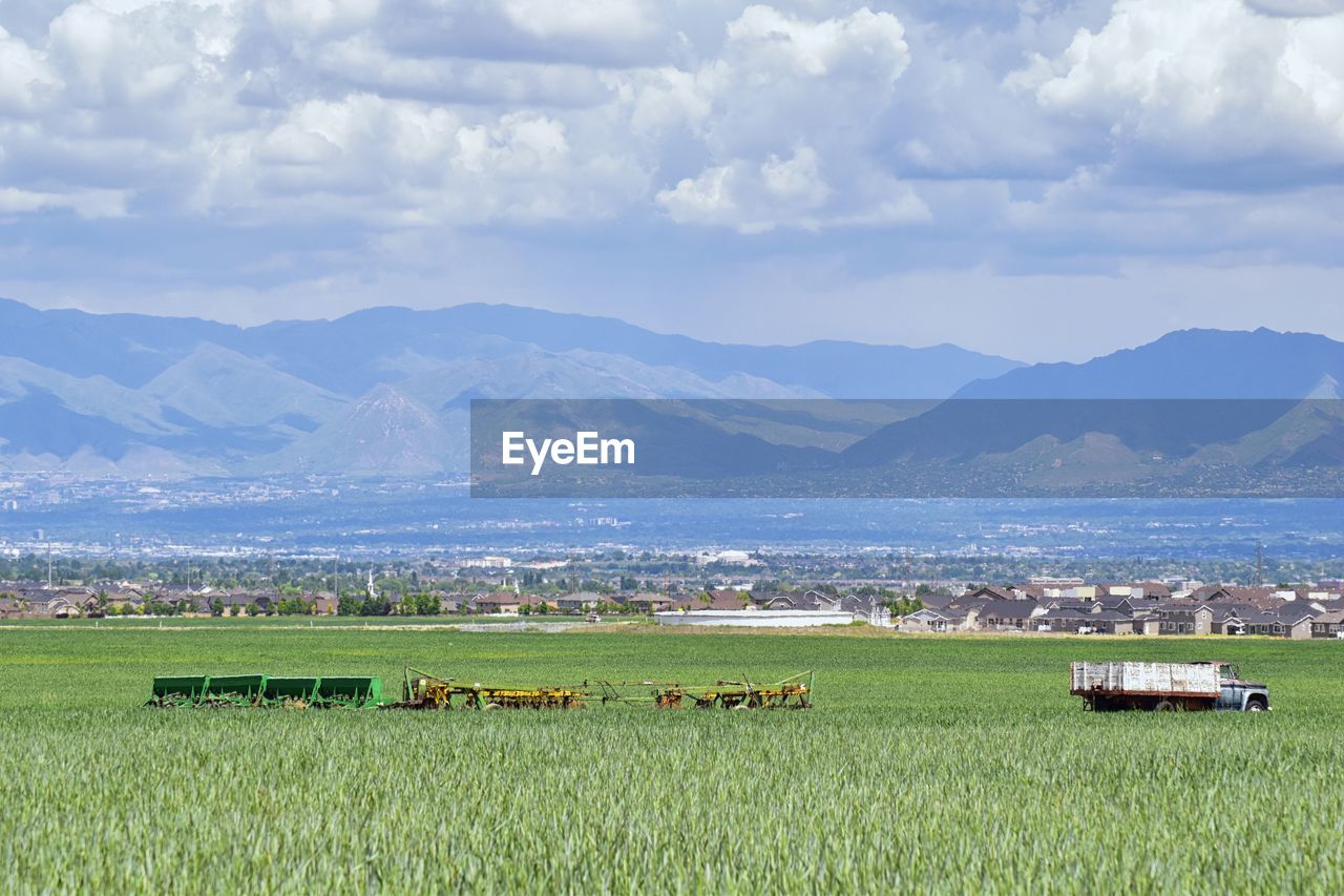Vintage farm truck and harvest machinery with rocky mountains, great salt lake valley utah. usa.