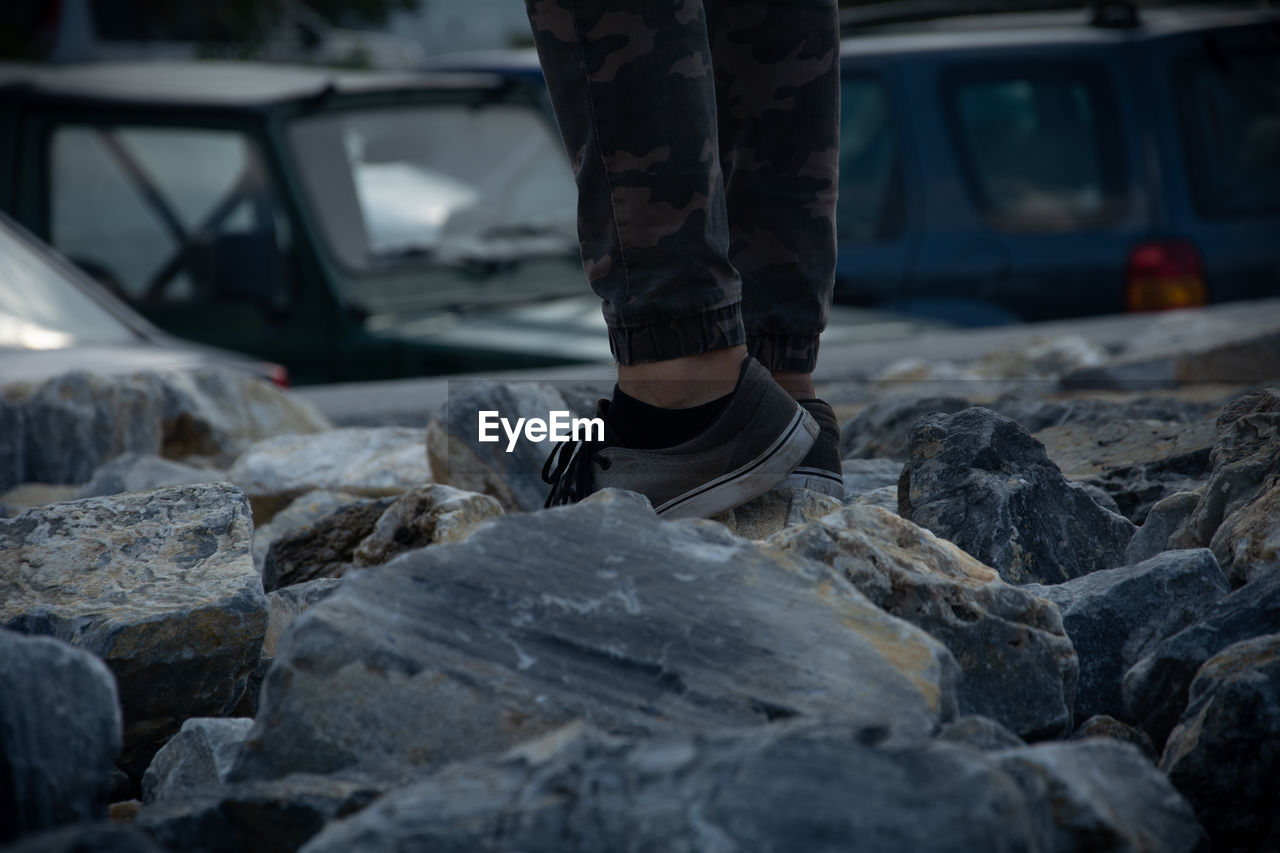 Low section of person standing on rocks