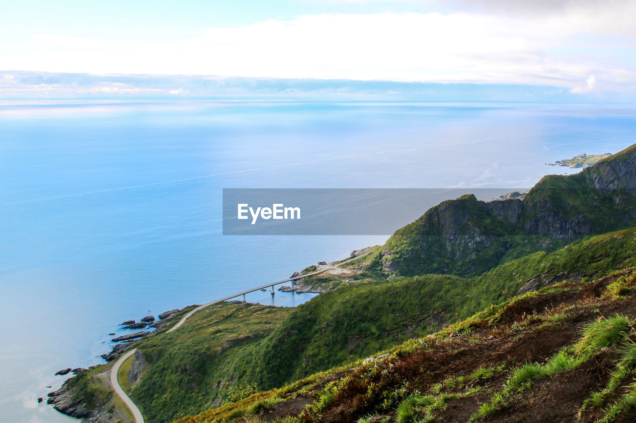 Scenic view of sea and bridge against sky