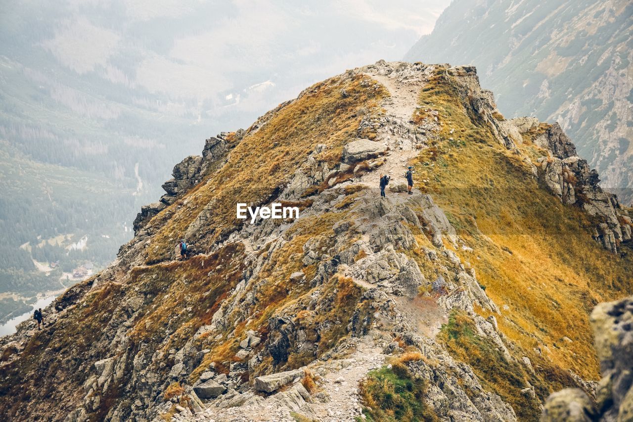 Aerial view of hikers on mountain against sky