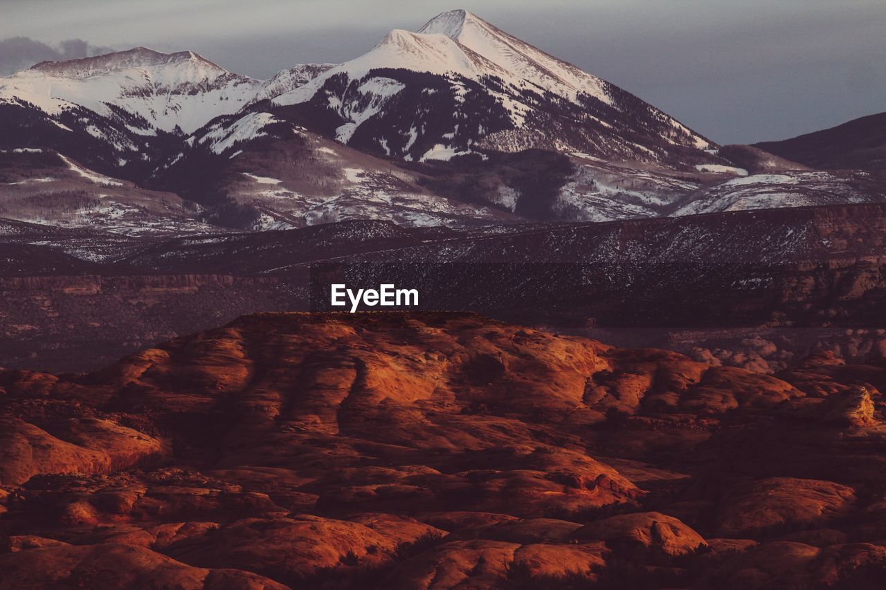 Scenic view of snowcapped mountains against sky during winter