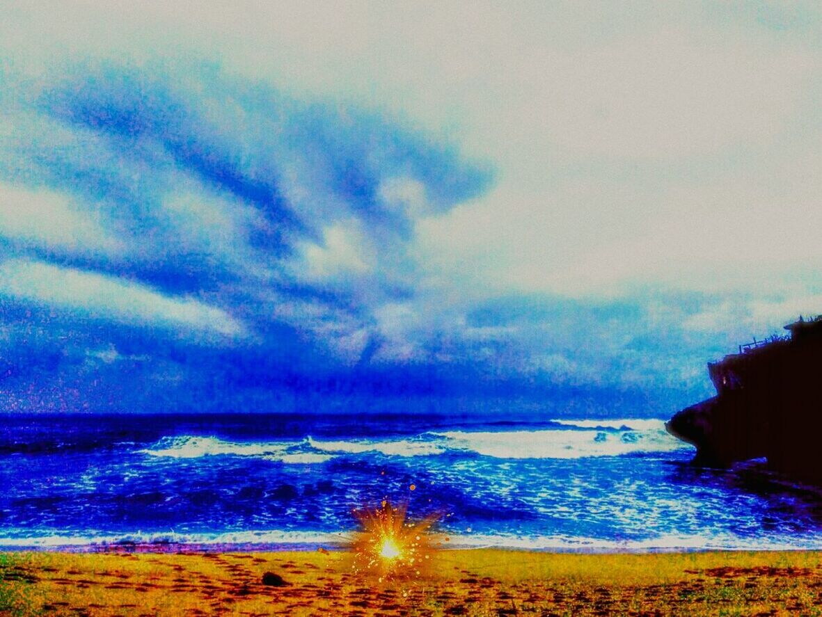 VIEW OF CALM BEACH AGAINST BLUE SKY