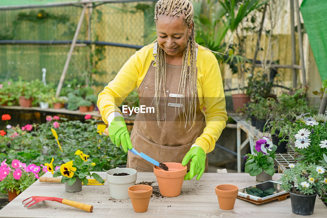 African american woman working in hothouse