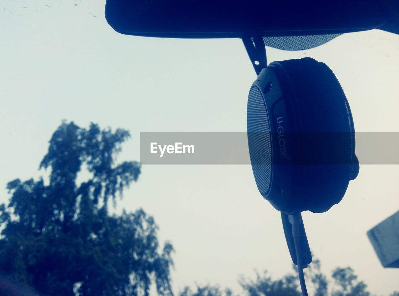 LOW ANGLE VIEW OF CLOTHES HANGING ON TREE AGAINST SKY