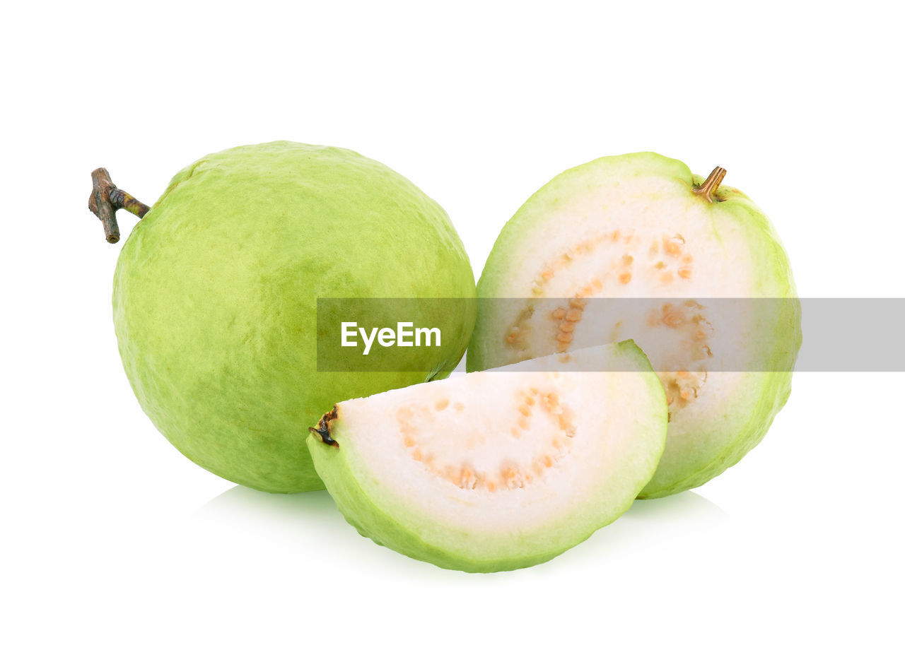 CLOSE-UP OF APPLE AGAINST GREEN BACKGROUND