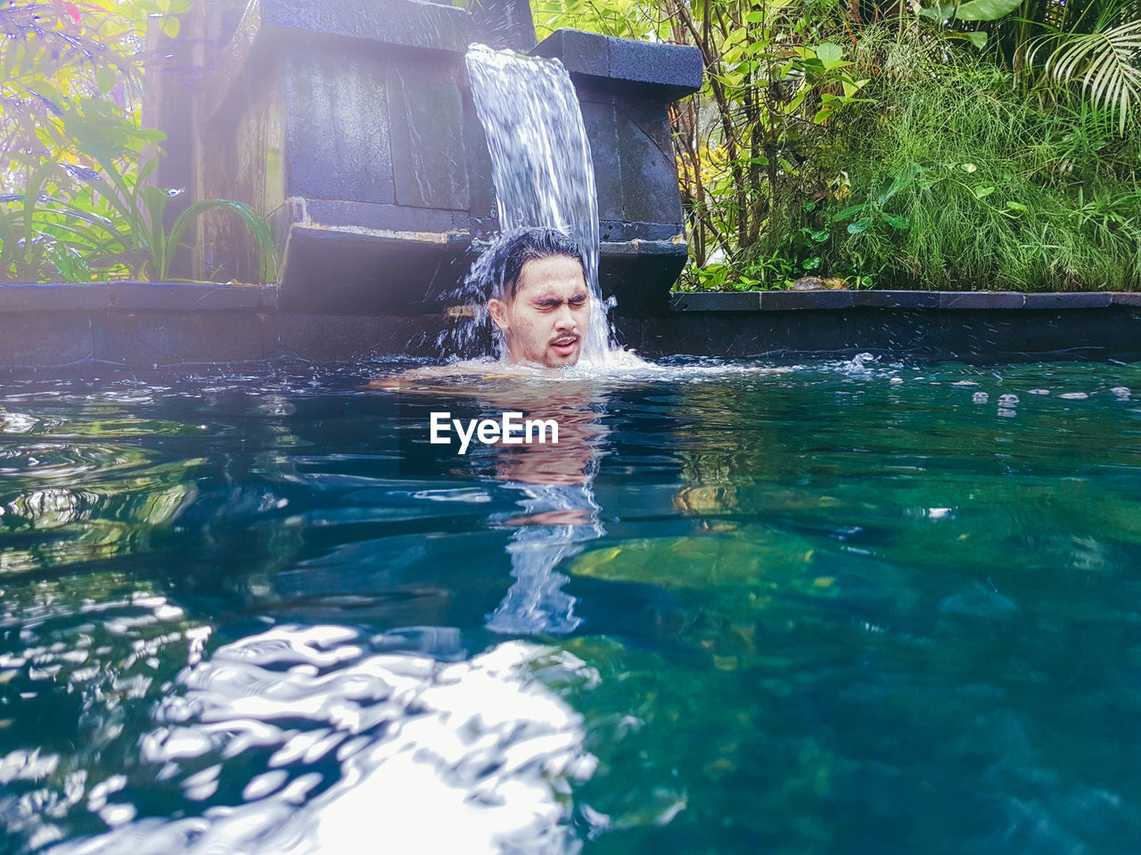 Young man swimming in pool