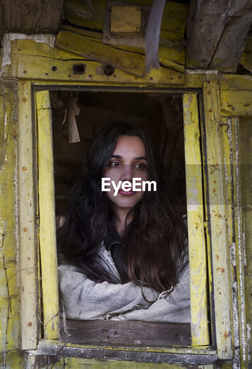 PORTRAIT OF A BEAUTIFUL YOUNG WOMAN IN ABANDONED ROOM