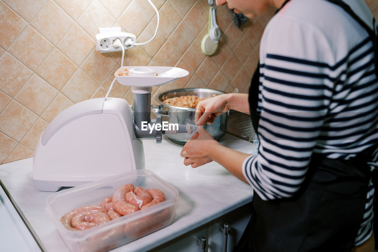 midsection of man washing hands in bathroom