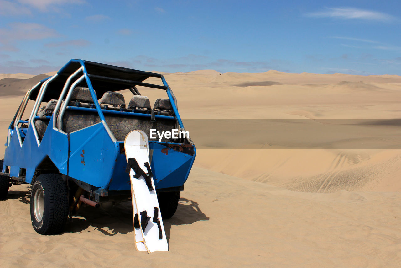 Scenic view of desert against blue sky