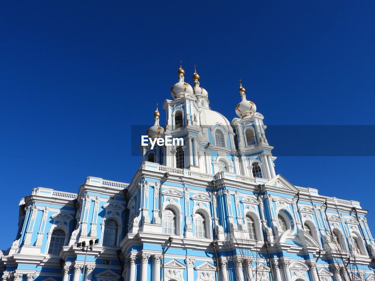 Low angle view of historic building against clear blue sky