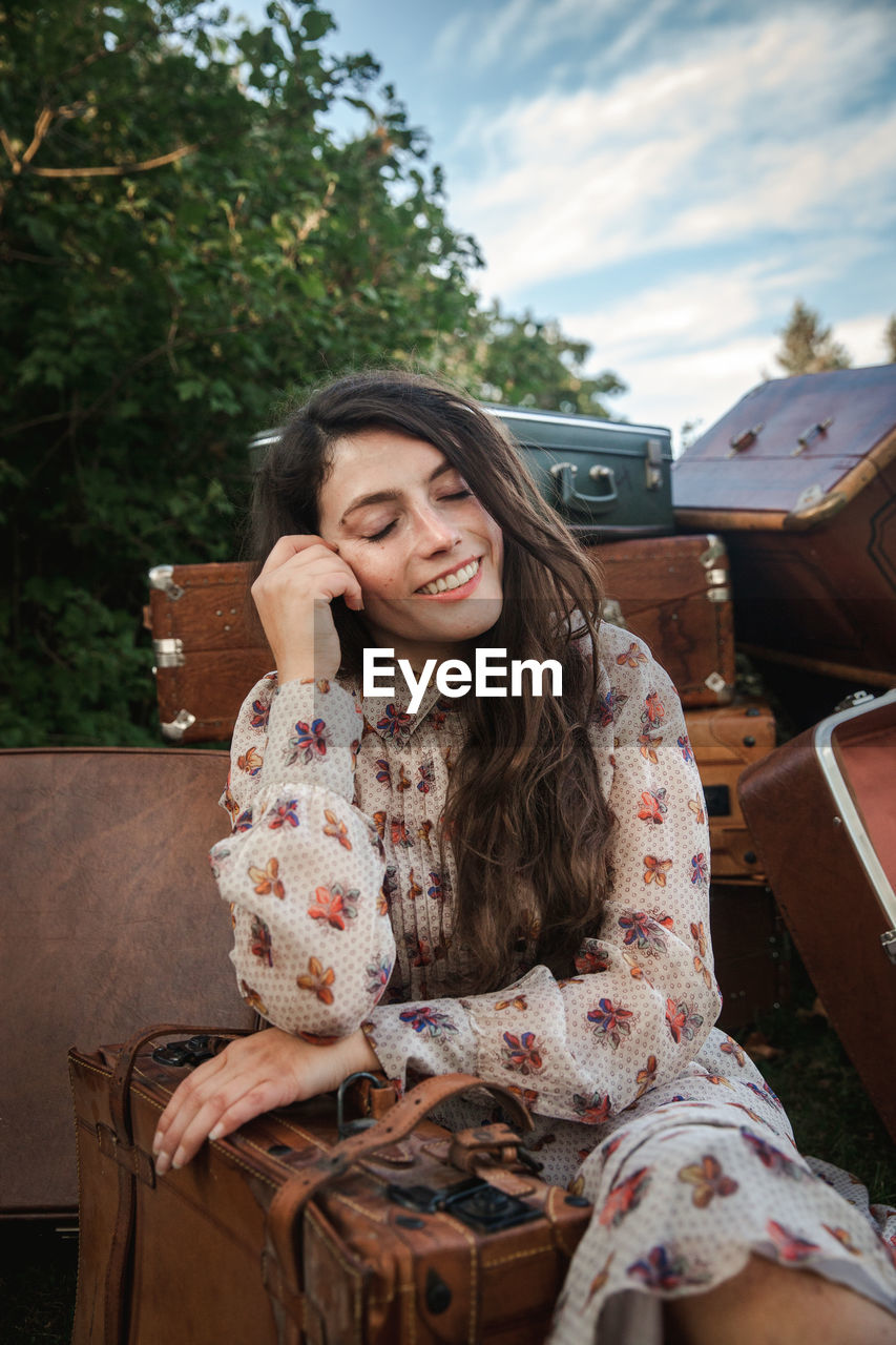 Smiling young woman sitting outdoors