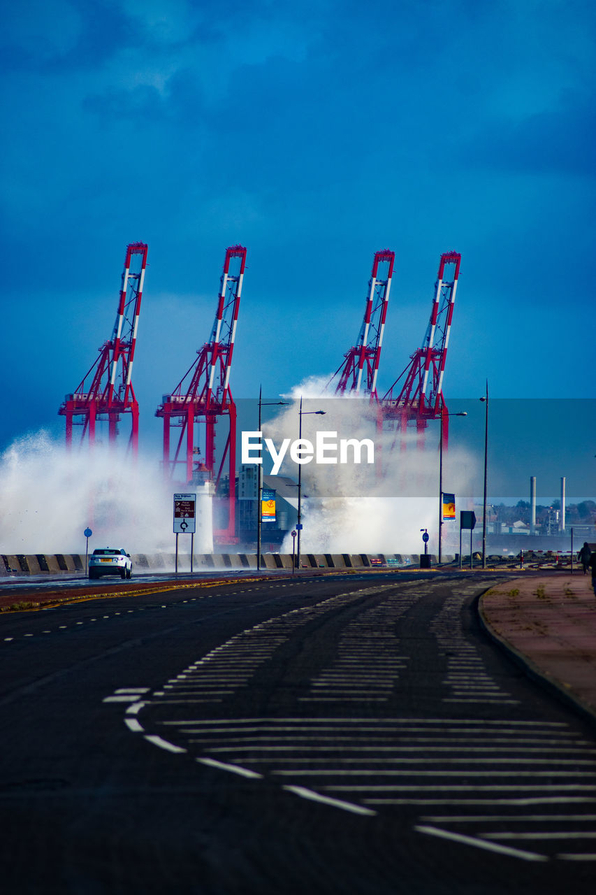 View of industry against blue sky