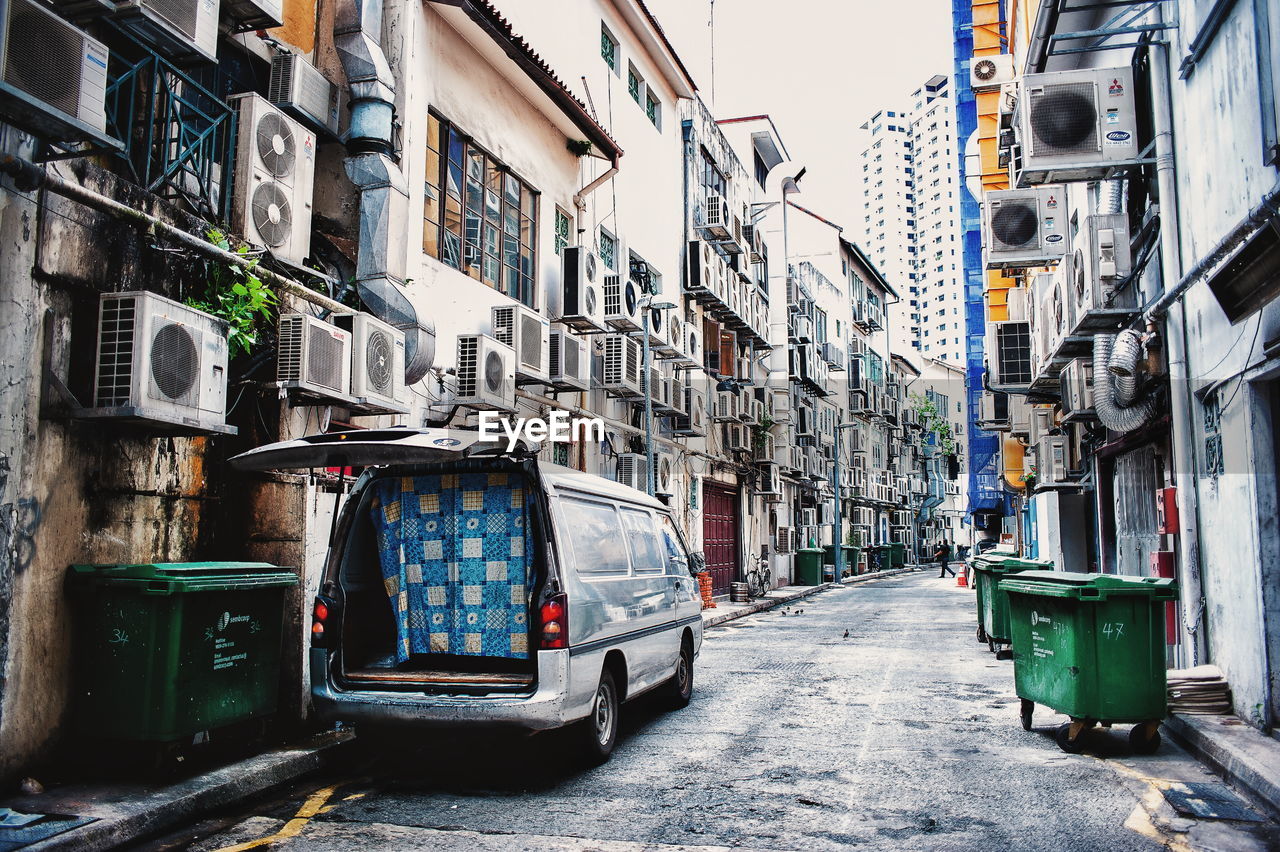 Van parked on street amidst residential buildings