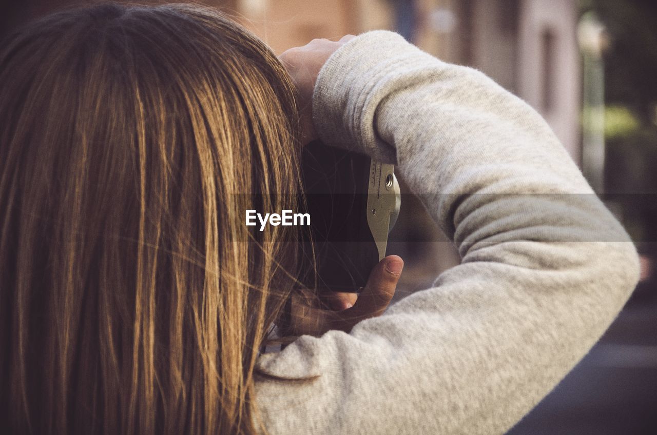 Close-up of girl photographing from camera