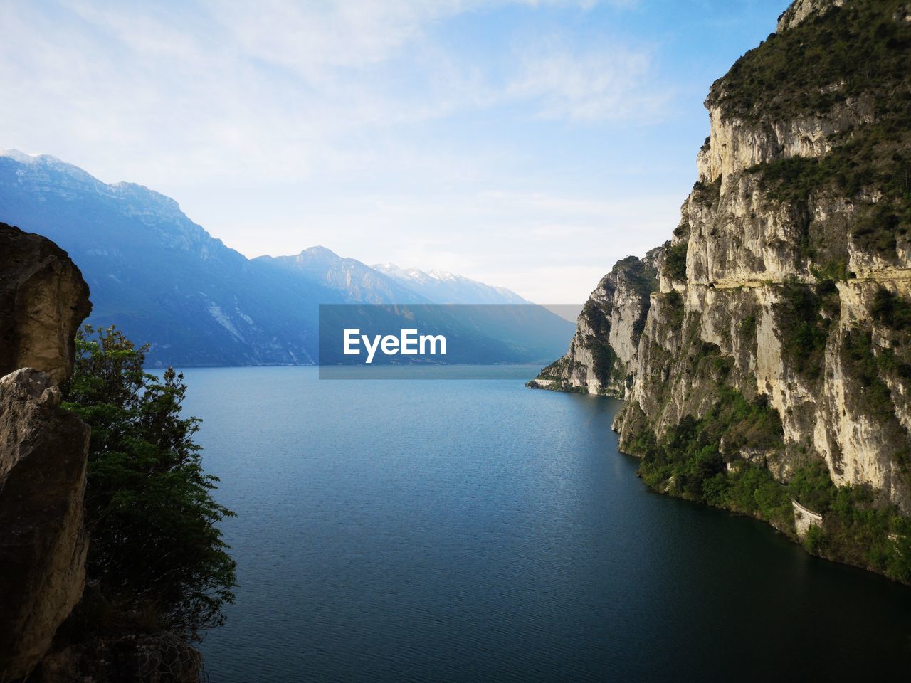 Scenic view of sea and mountains against sky