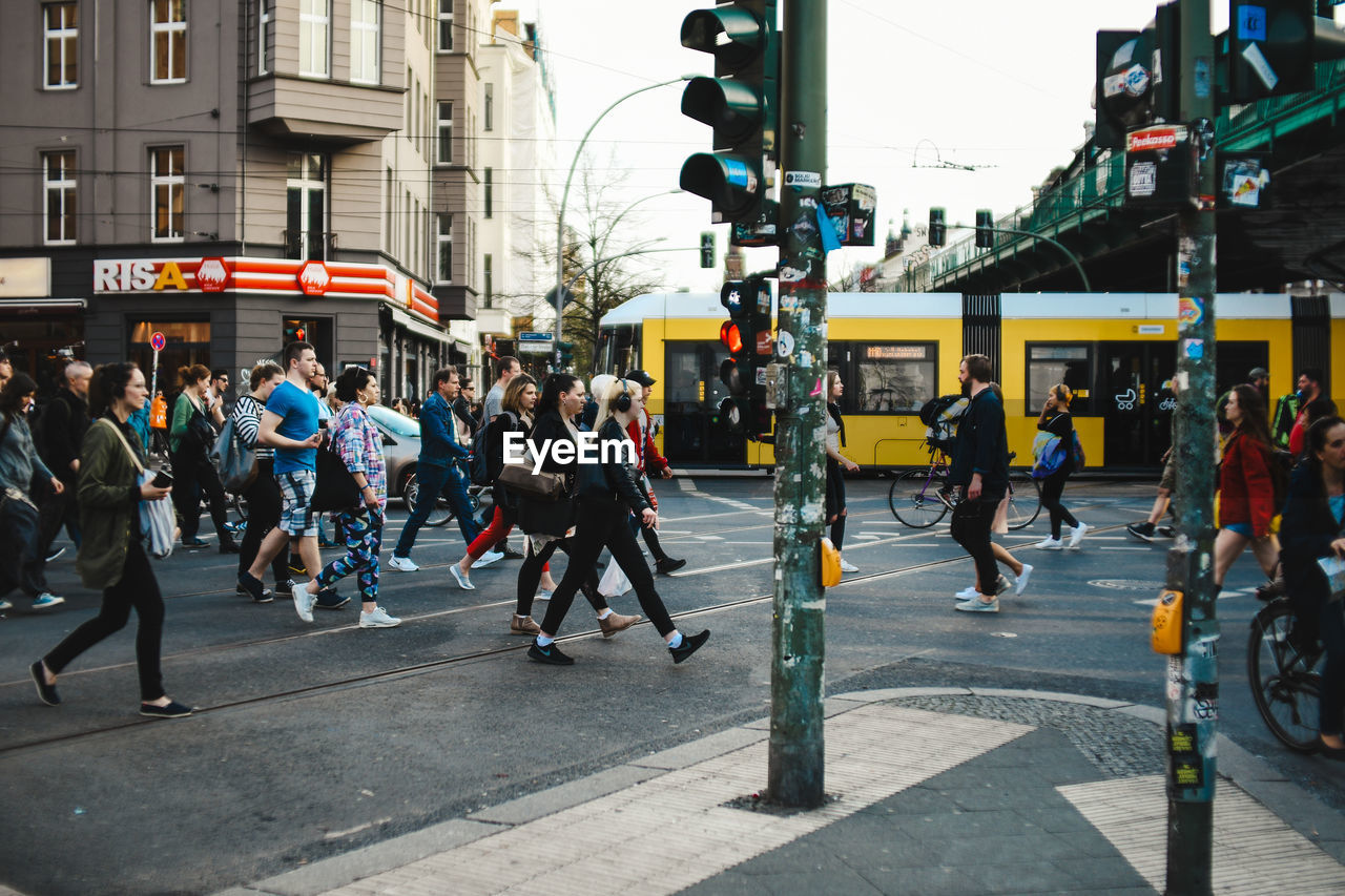 PEOPLE WALKING ON STREET IN CITY