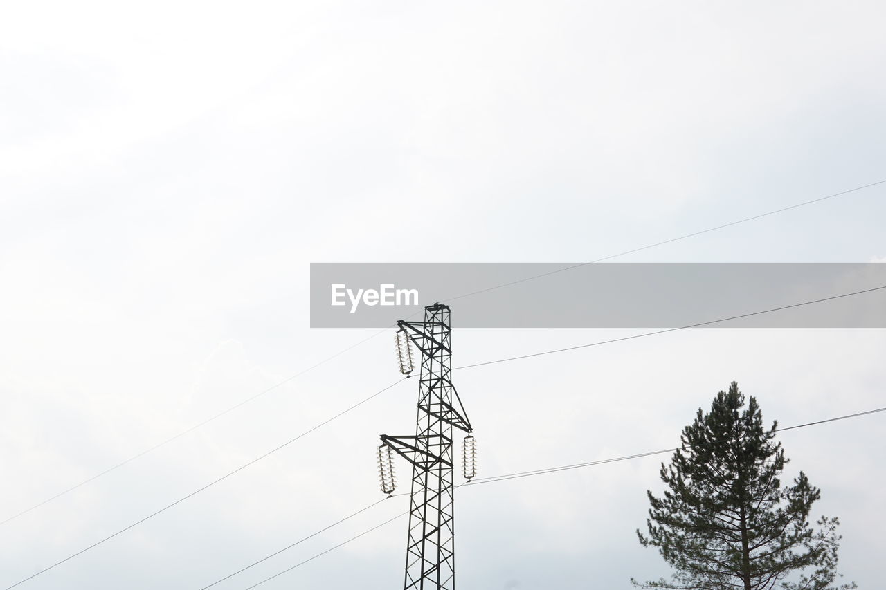 Low angle view of electricity pylon against sky