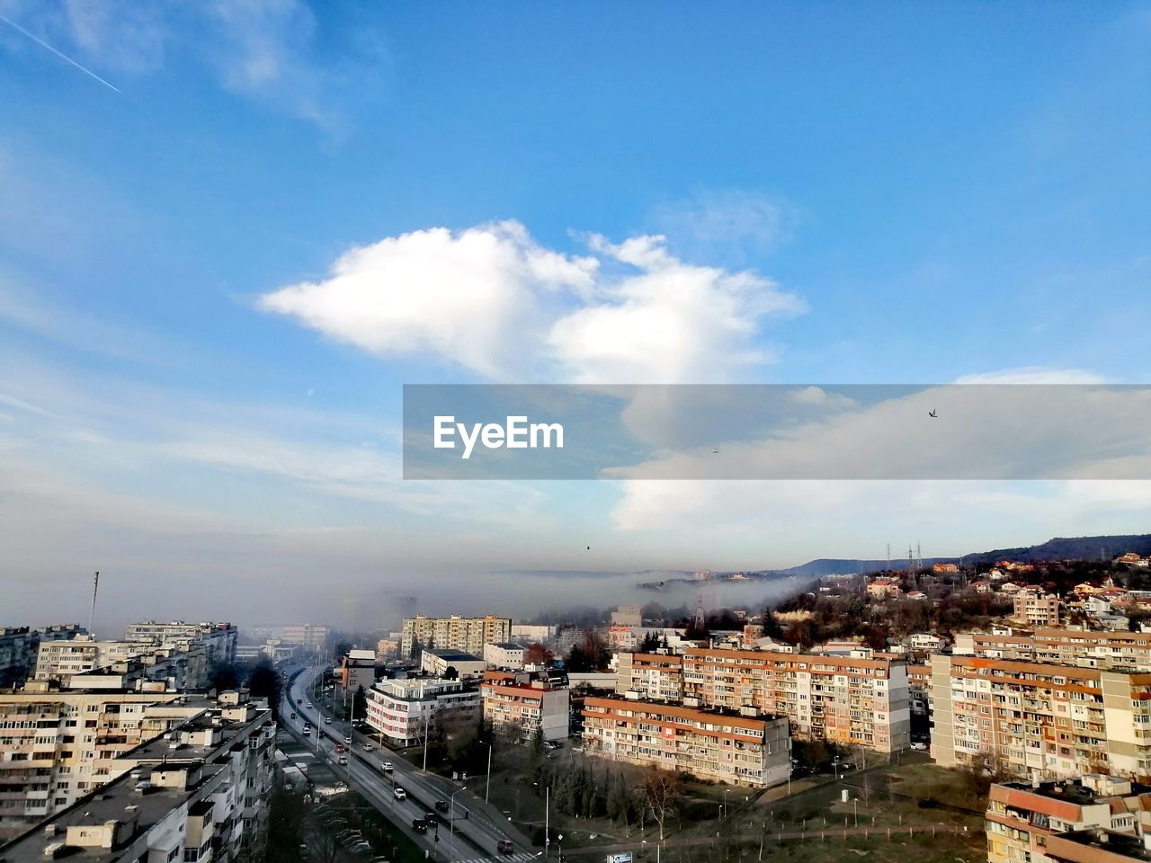 HIGH ANGLE VIEW OF BUILDINGS AGAINST SKY