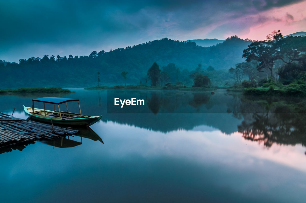 Scenic view of lake against sky during sunrise