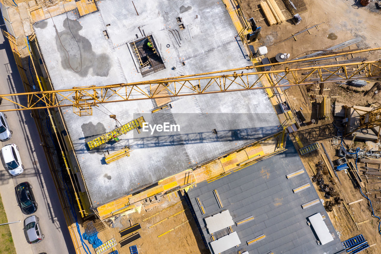Crane and highrise construction site. aerial view