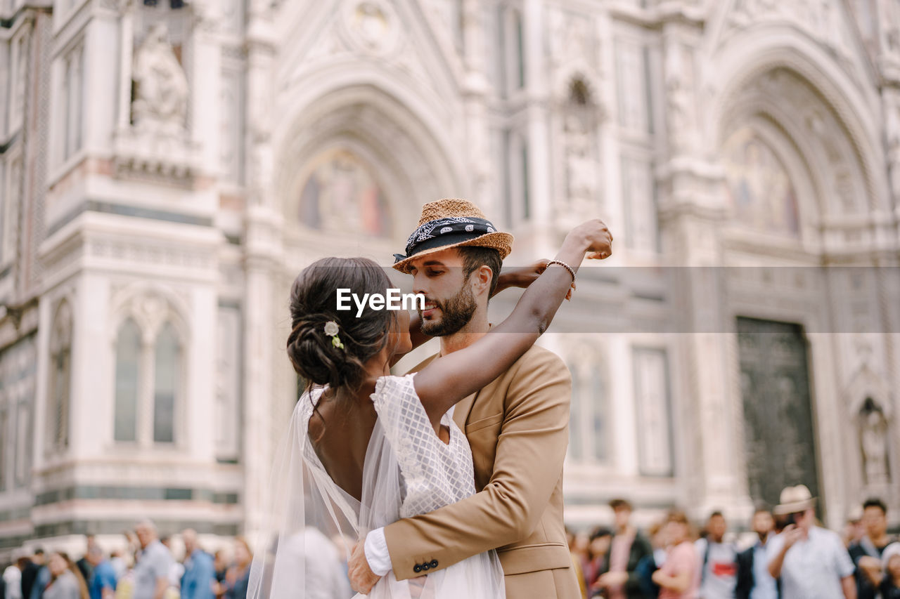 Man and woman standing in front of historical building