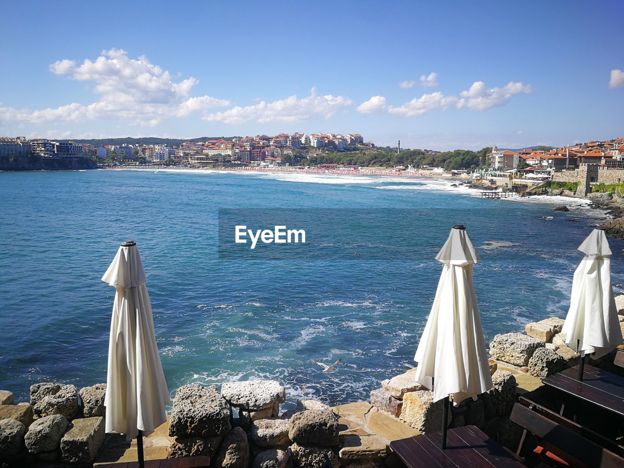 Panoramic view of sea and buildings against sky