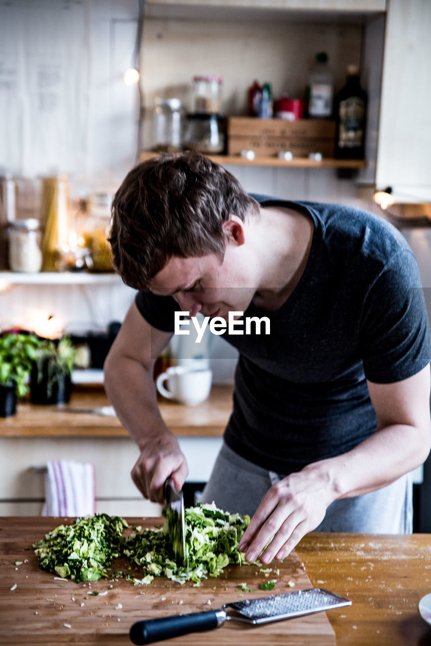 Man preparing food in kitchen at home