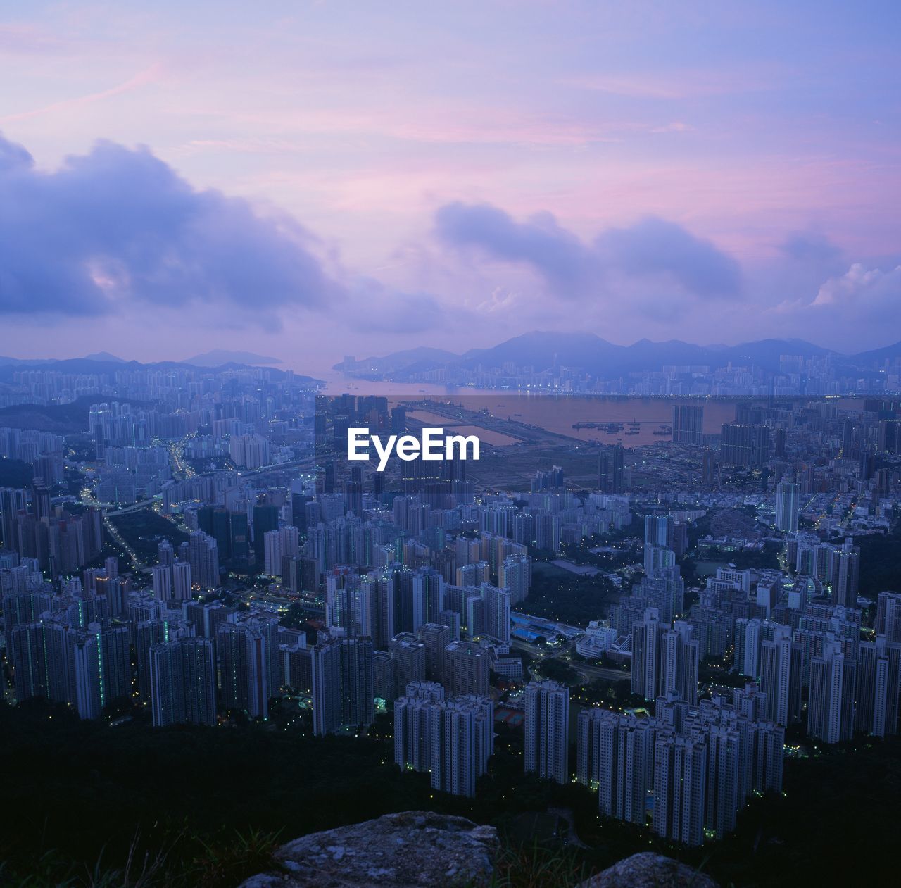 Aerial view of buildings in city at sunset