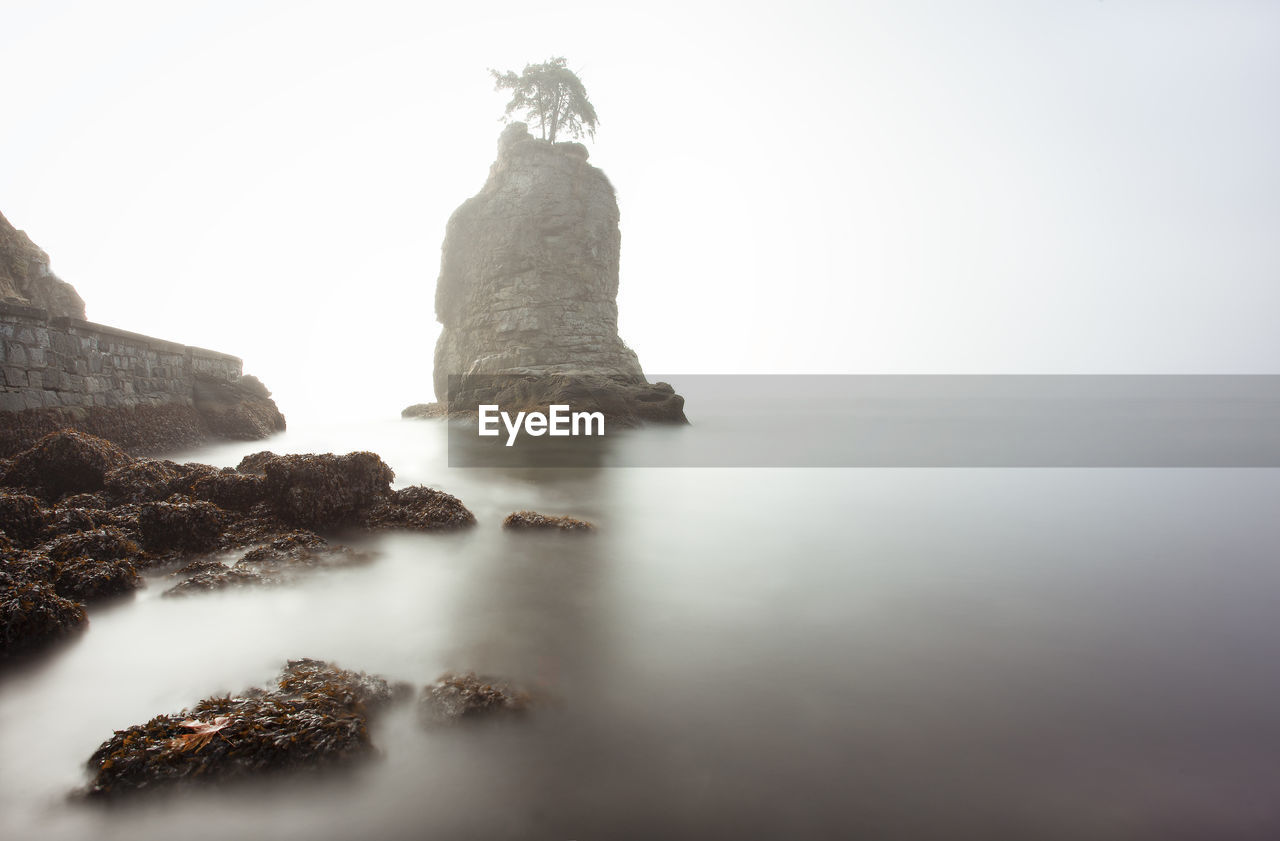 Rock formation in the ocean fog