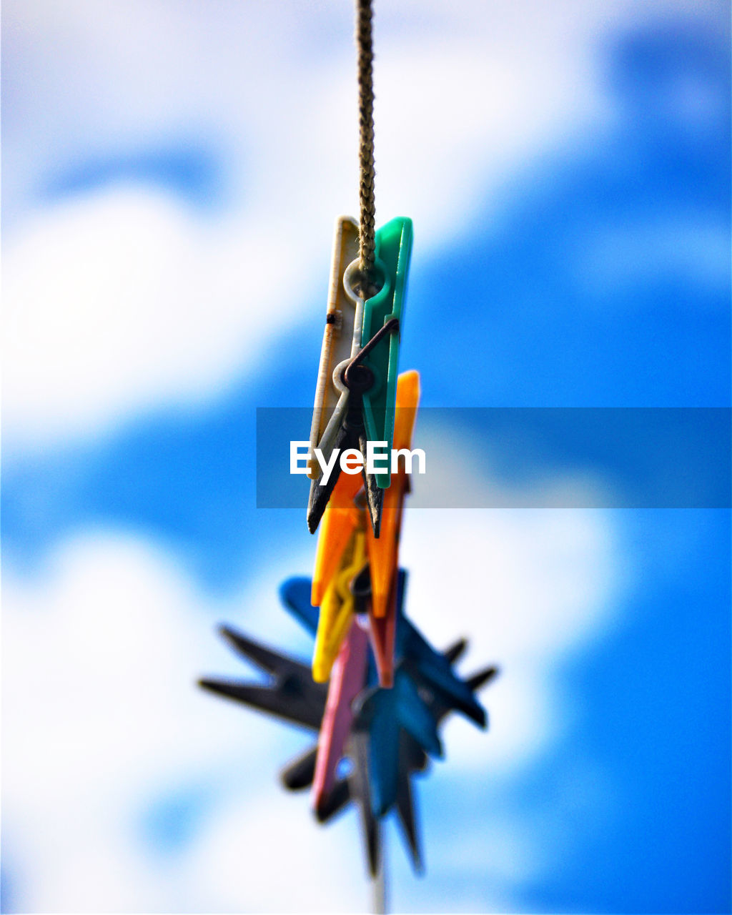 blue, no people, sky, nature, toy, hanging, day, cloud, outdoors, focus on foreground, aircraft, macro photography, vehicle, close-up, multi colored