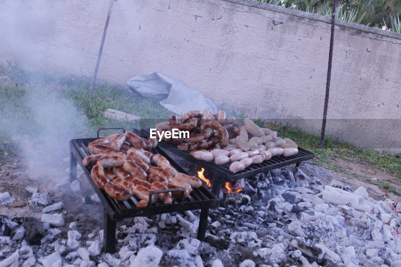 burning, heat, fire, food, barbecue, food and drink, smoke, barbecue grill, flame, day, nature, no people, meat, coal, outdoors, grilled, outdoor grill, freshness, high angle view, firewood, preparing food, log, metal