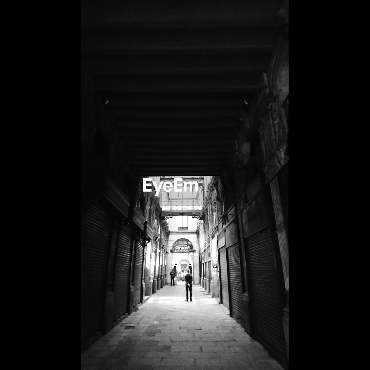 MAN STANDING IN CORRIDOR