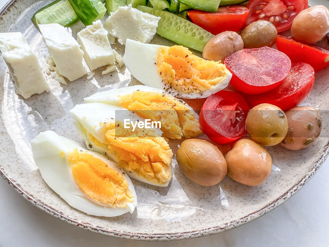 Breakfast, healthy breakfast plate with slices of boiled egg, cheese, salad on plate. delicious food 