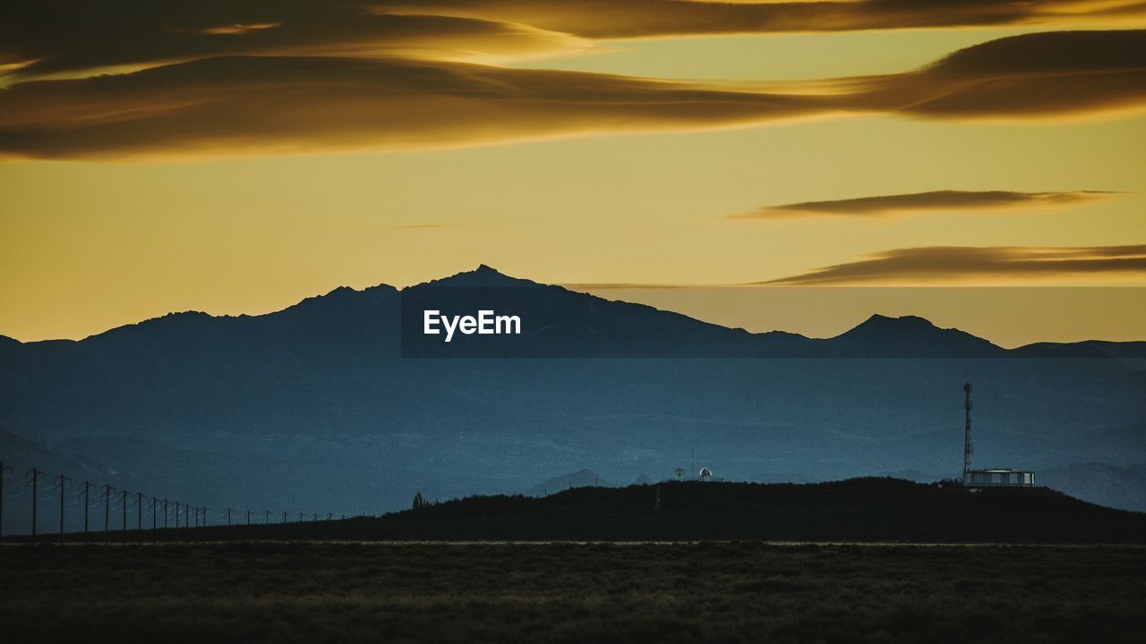 SILHOUETTE OF MOUNTAINS AT SUNSET
